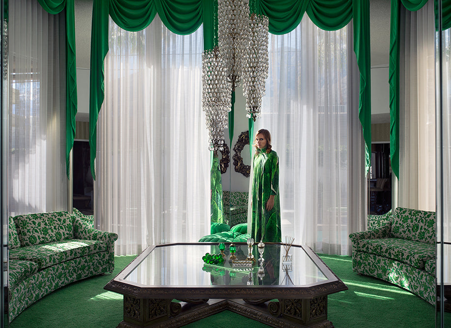 woman standing in green themed living room