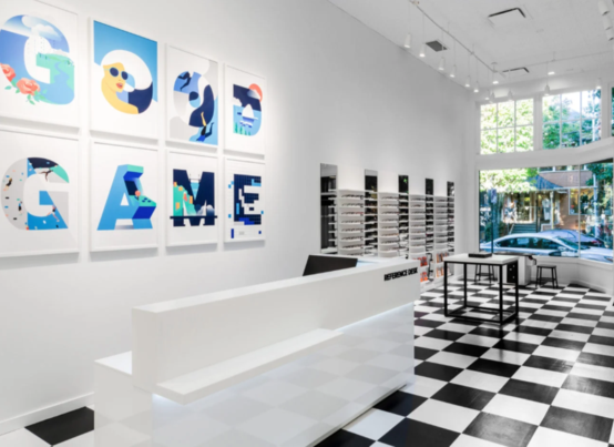 picture of store front with custom framed abstracts letters spelling out good game in shades of blue