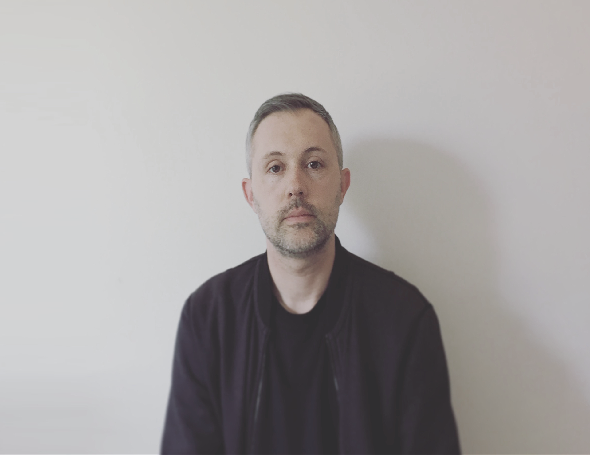 Photo of Bryan Byczek wearing black shirt and jacket