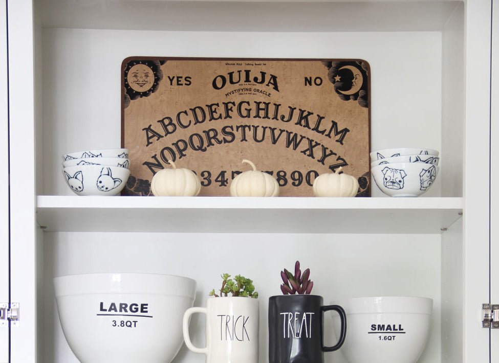 Halloween decor sitting on white shelfs