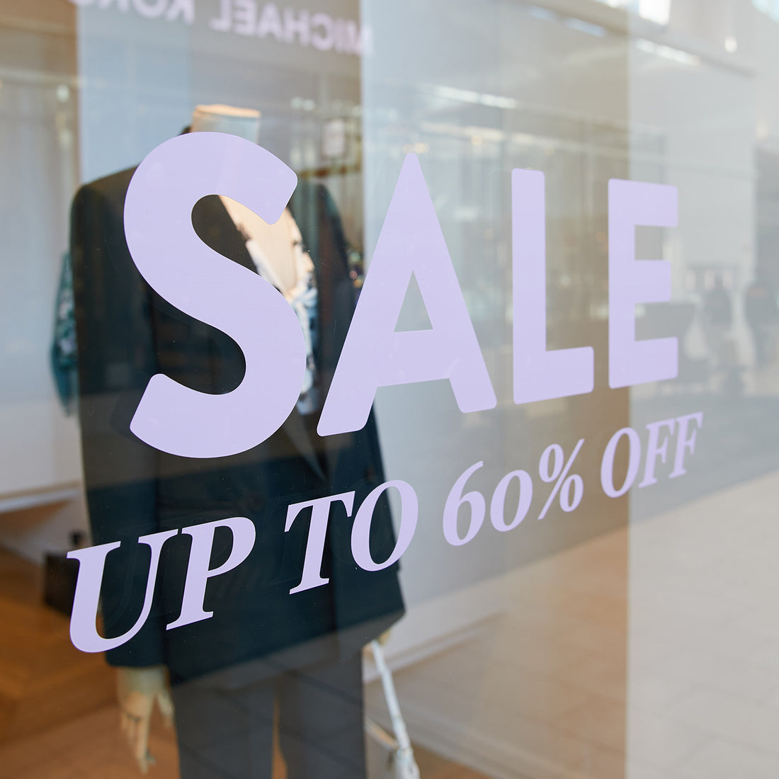 custom decal made for a storefront window that says sale up to 60 percent off in pink
