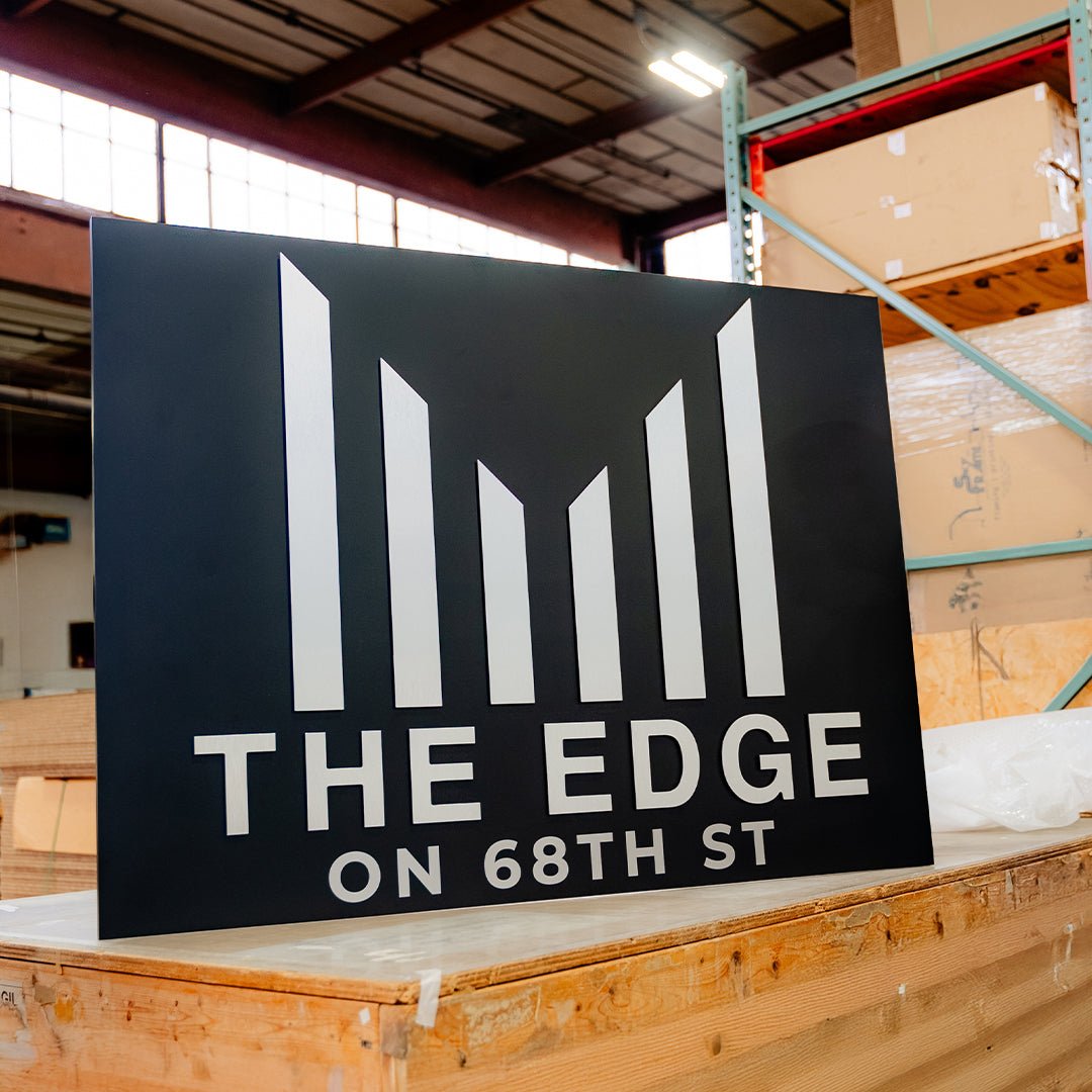 Custom CNC-cut building signage for The Edge on 68th St installed by Skyframe