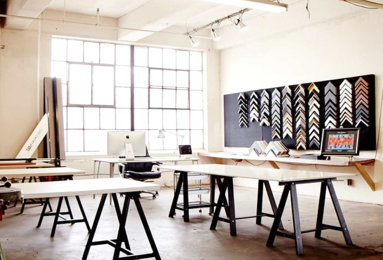 Framing company New York show room with large tables and frame samples