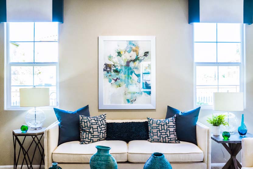 customers beautiful interior design blue themed living room with skyframe custom framed artwork to match the aesthetic