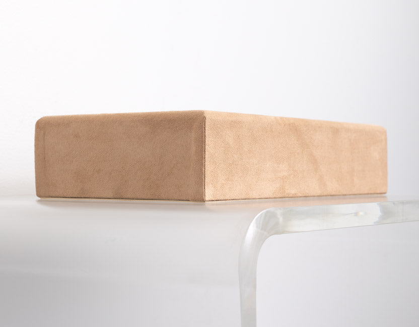 flat riser covered in tan suede material made for retail store displays