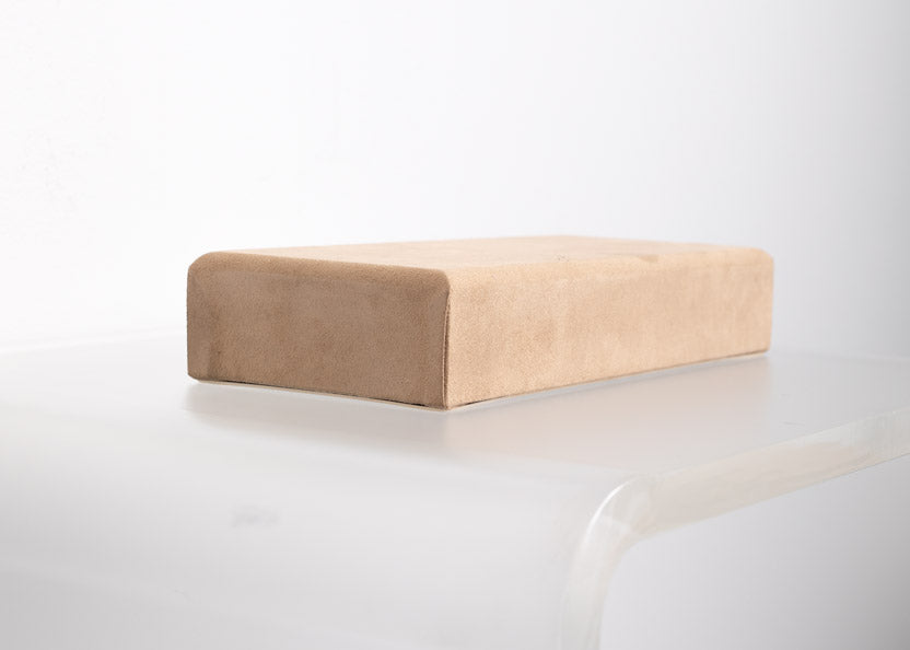 flat riser covered in tan suede material made for retail store displays