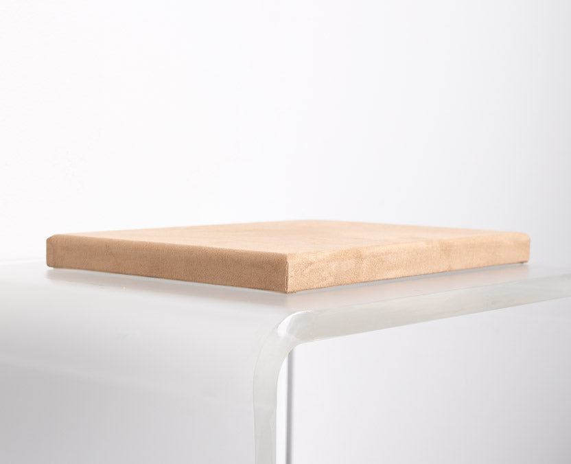 flat riser covered in tan suede material made for retail store displays