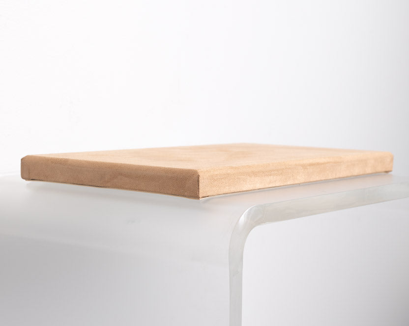 flat riser covered in tan suede material made for retail store displays