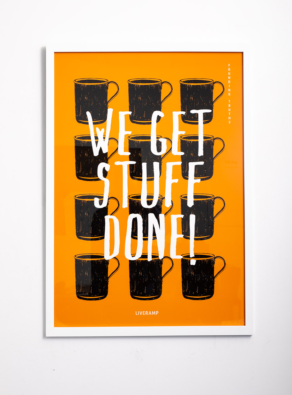 orange we get stuff done! with black mugs framed in white thin frame