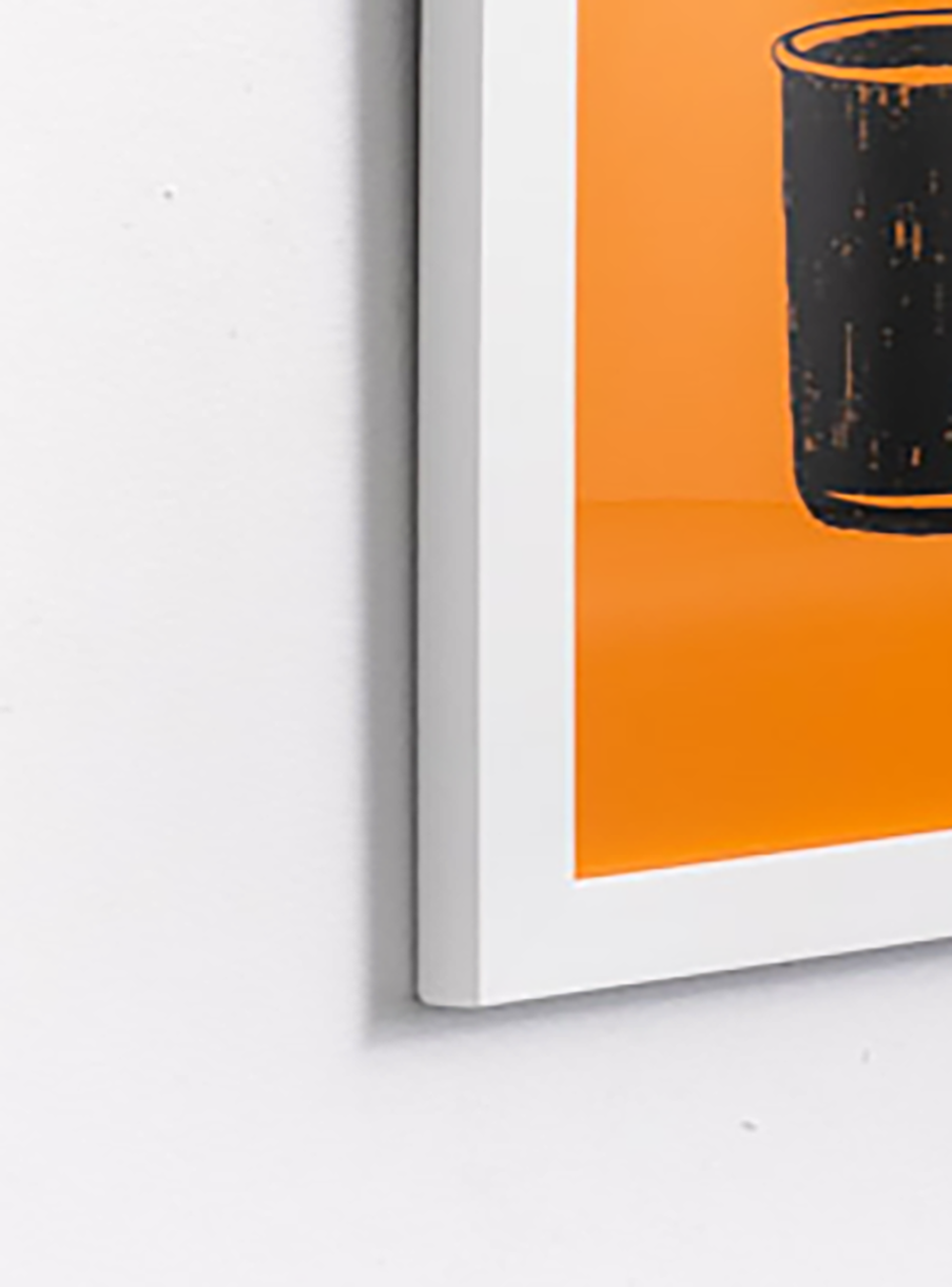 close up orange we get stuff done! with black mugs framed in white thin frame