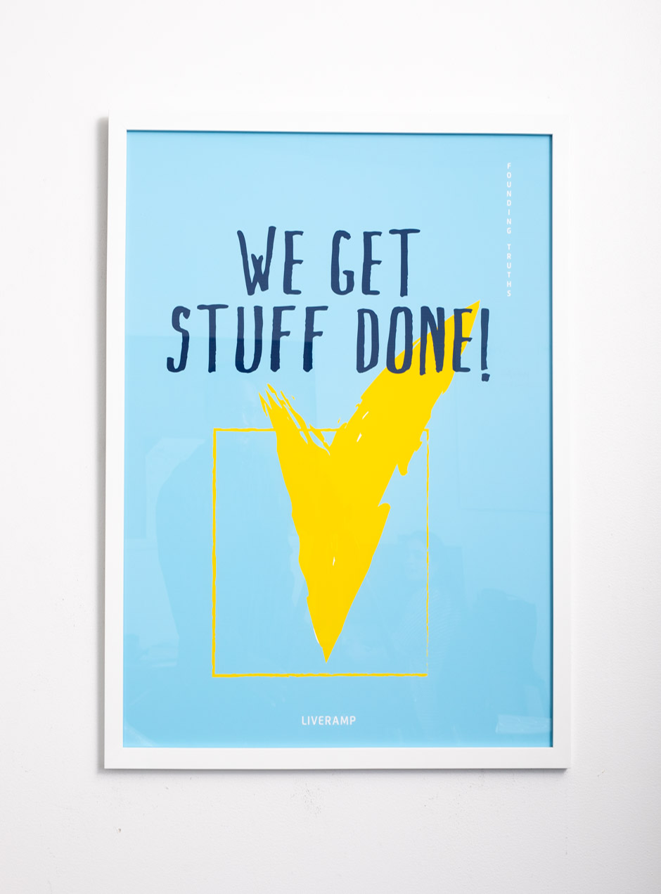 light blue we get stuff done! with yellow checked box in thin white frame