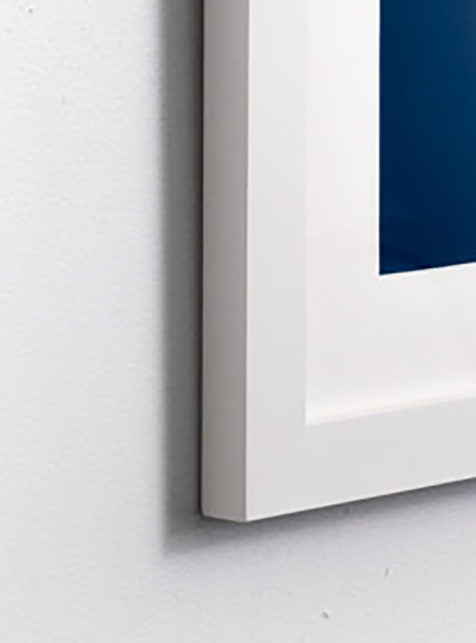 orange peace sign against blue background in white frame  close up