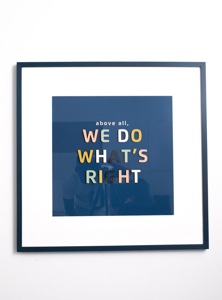 above all we do what's right multicolor fun graphic lettering on navy backdrop with wide white mat in navy frame