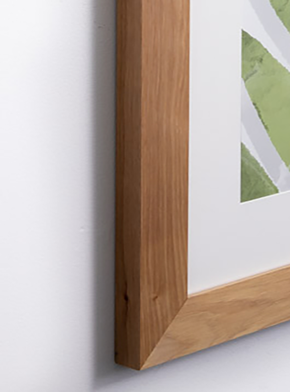 close up palm leaf in oak frame