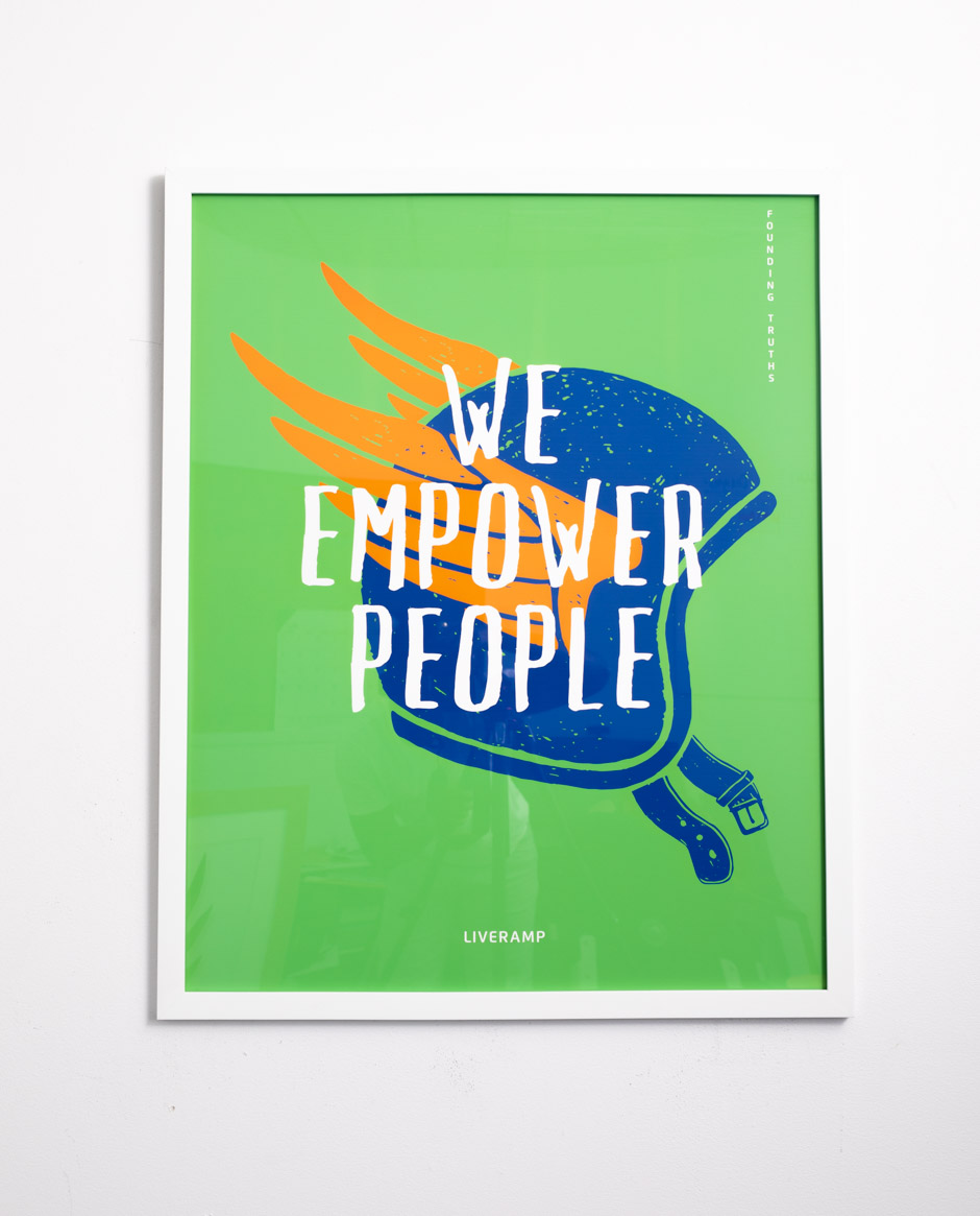 we empower people on green background with blue helmet in thin white frame