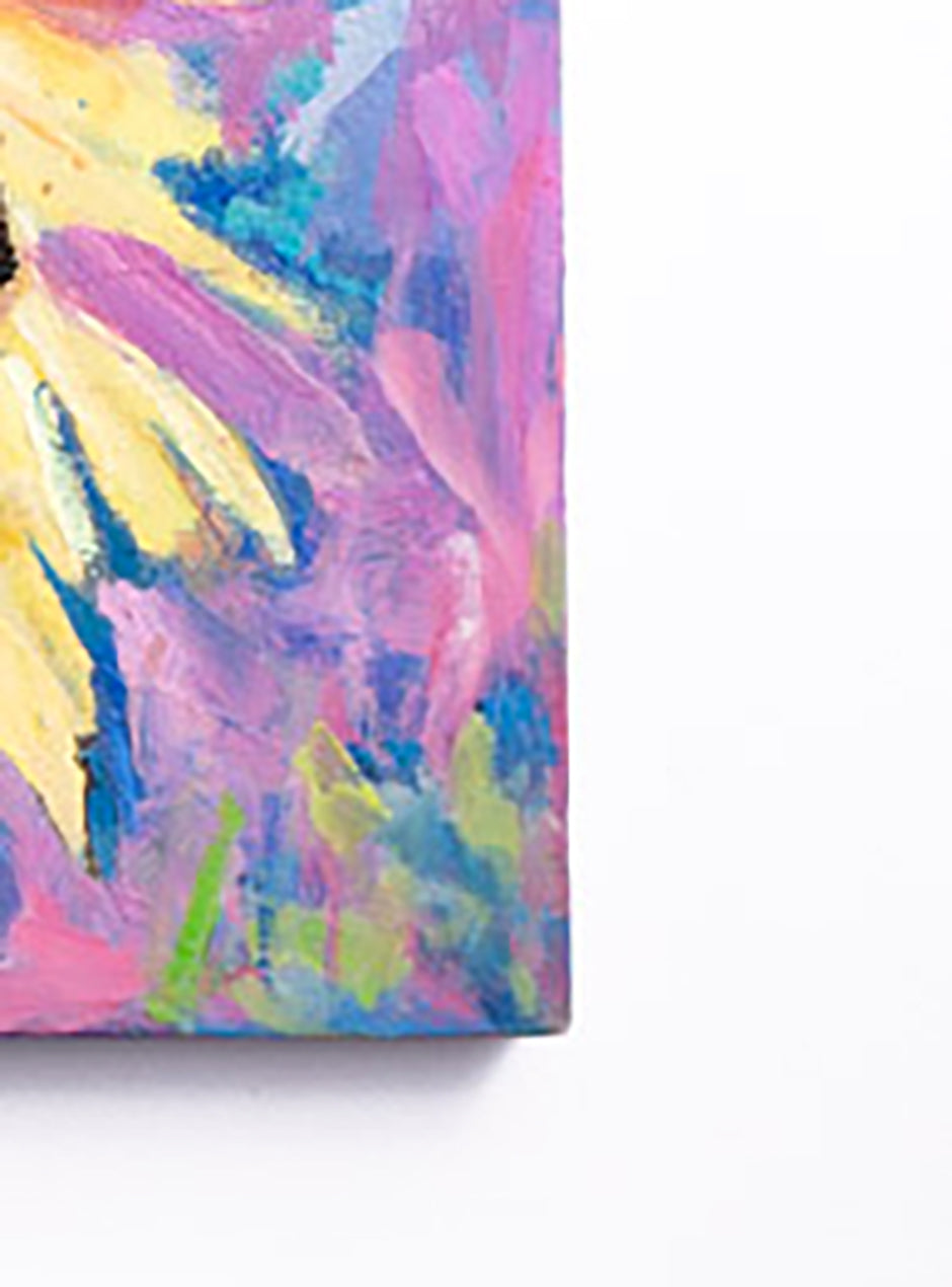 close up of corner of handpainted sunflowers pink, yellow, purple and red on canvas