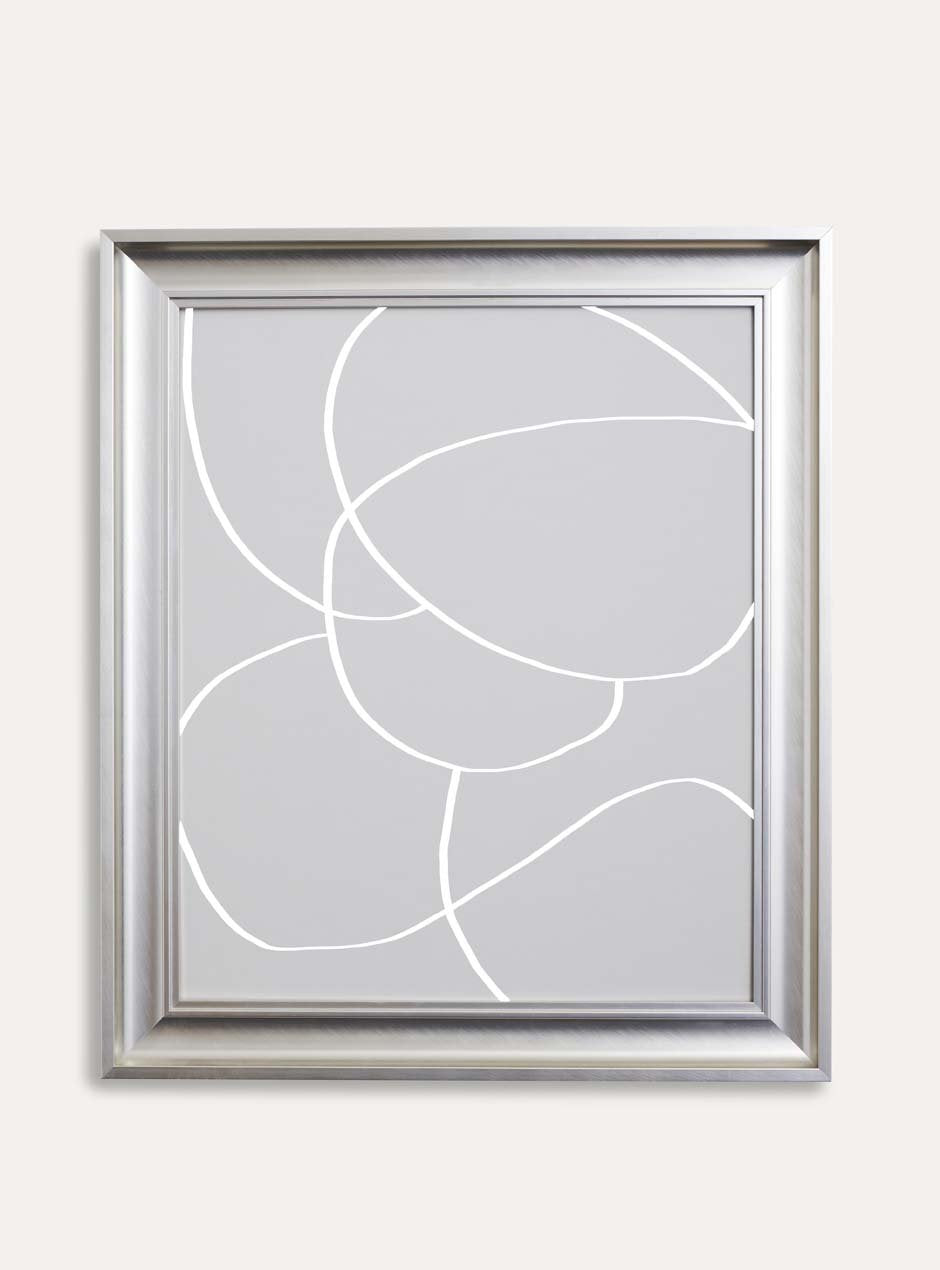 silver metallic shiny picture frame with depth and higher ridges showing circular modern abstract grey art against white wall