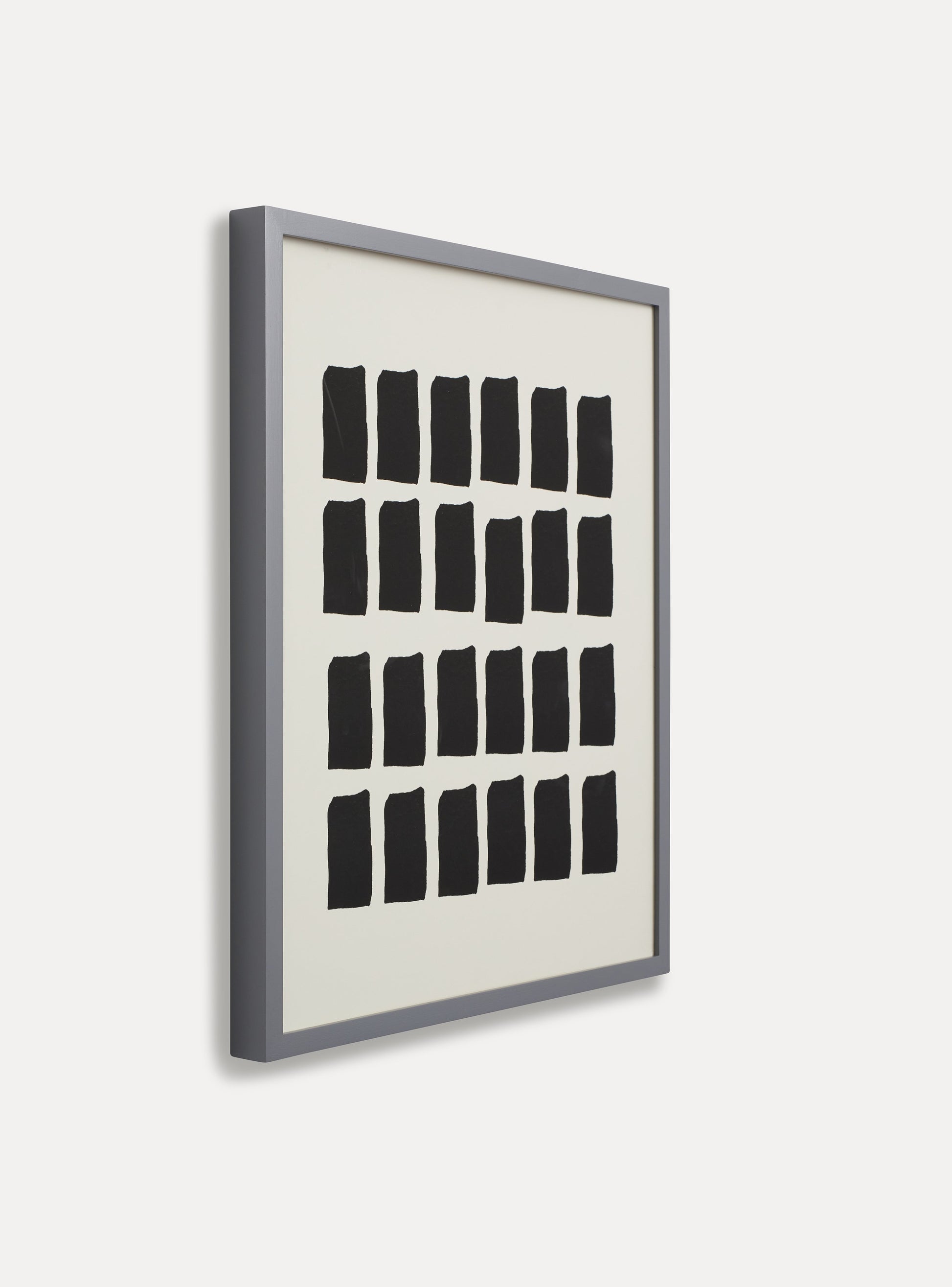Side photo of a wooden picture frame on an off-white wall