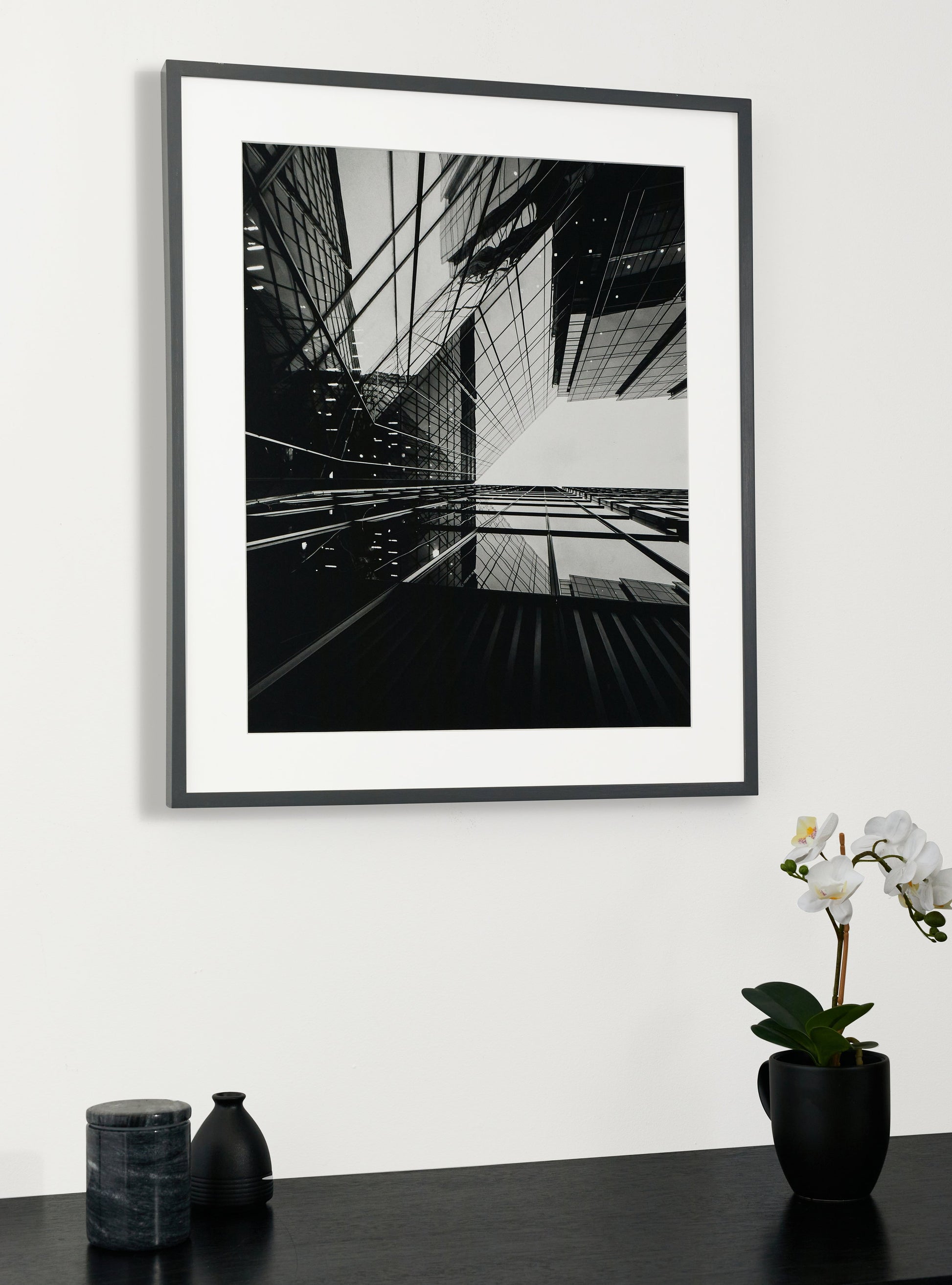 Photograph of a frame in a home with a table underneath showing various items