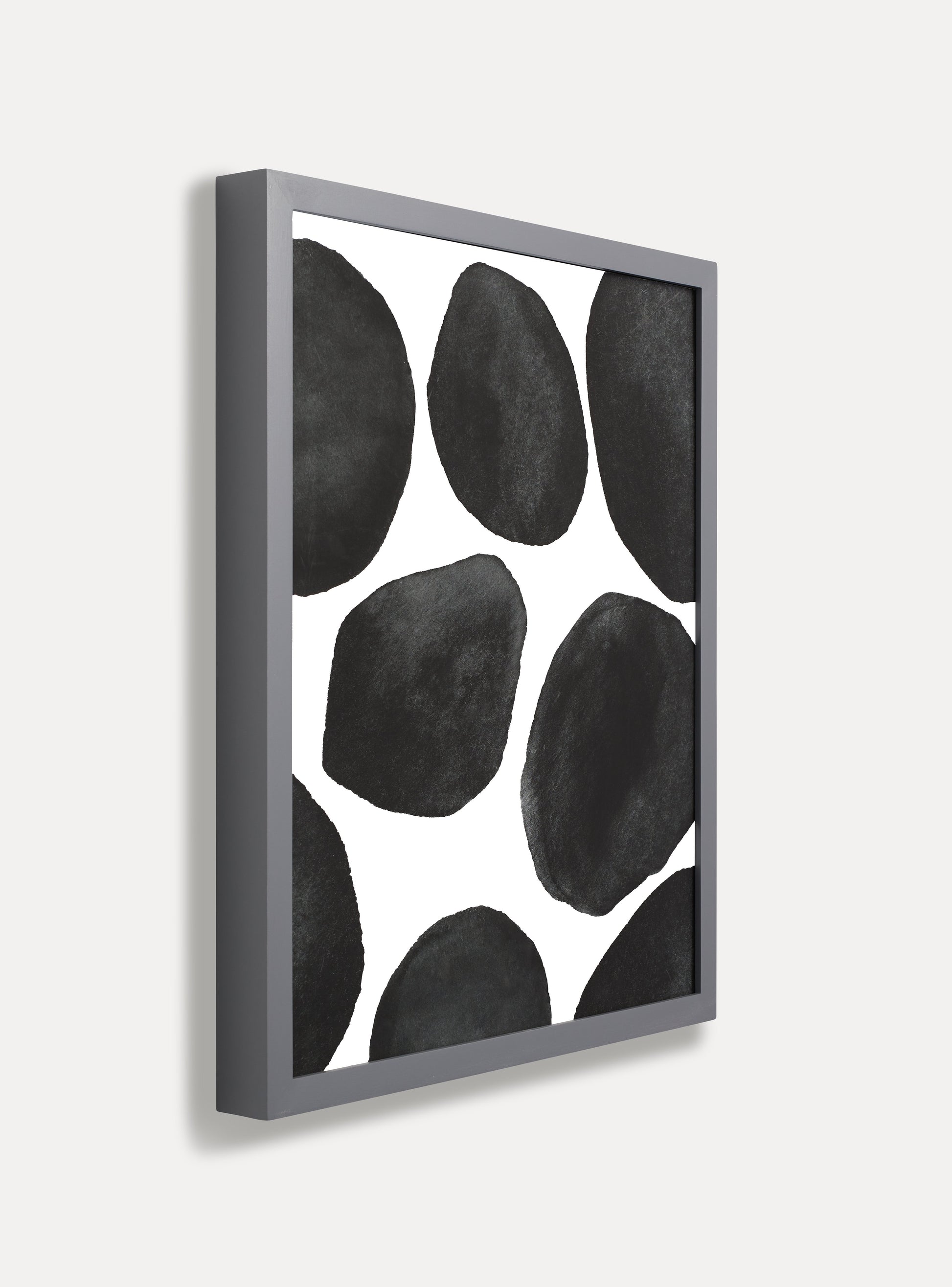 Side photo of a wooden picture frame on an off-white wall