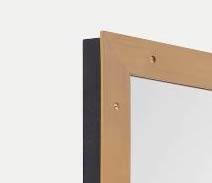 close up of top corner of custom brass framed mirror with screw detail
