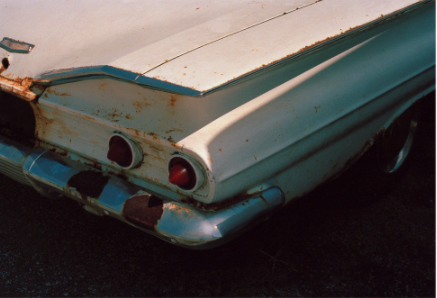 Vintage rusted white car print by jesse skupa with heavy shadows and a blue tone