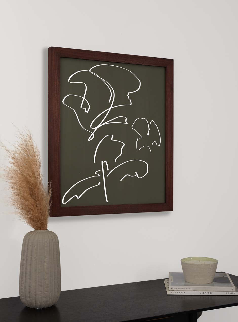 dark stained wooden frame holding abstract painting hung above table with various objects