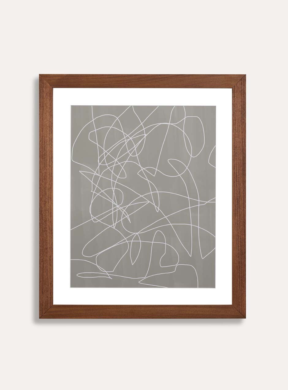 brown wooden frame holding abstract art