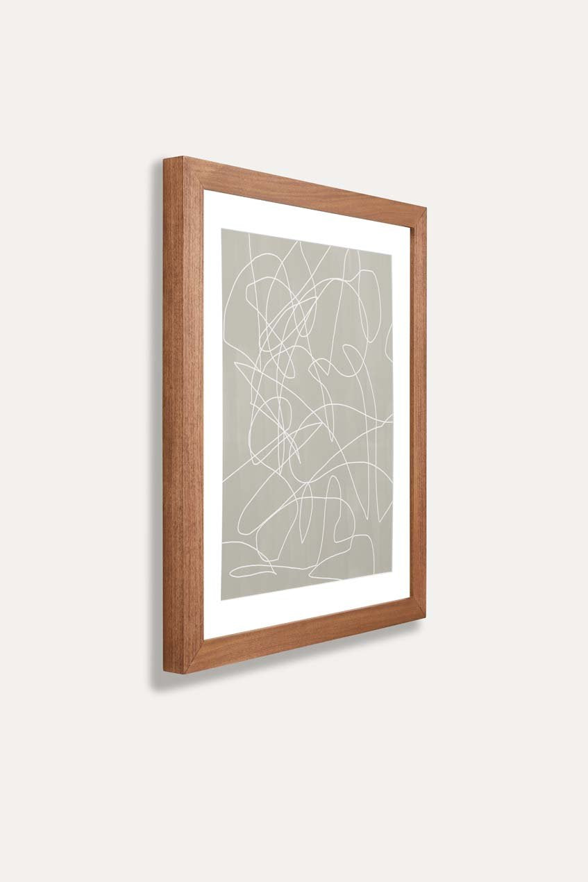 Side view of brown wooden frame holding abstract art