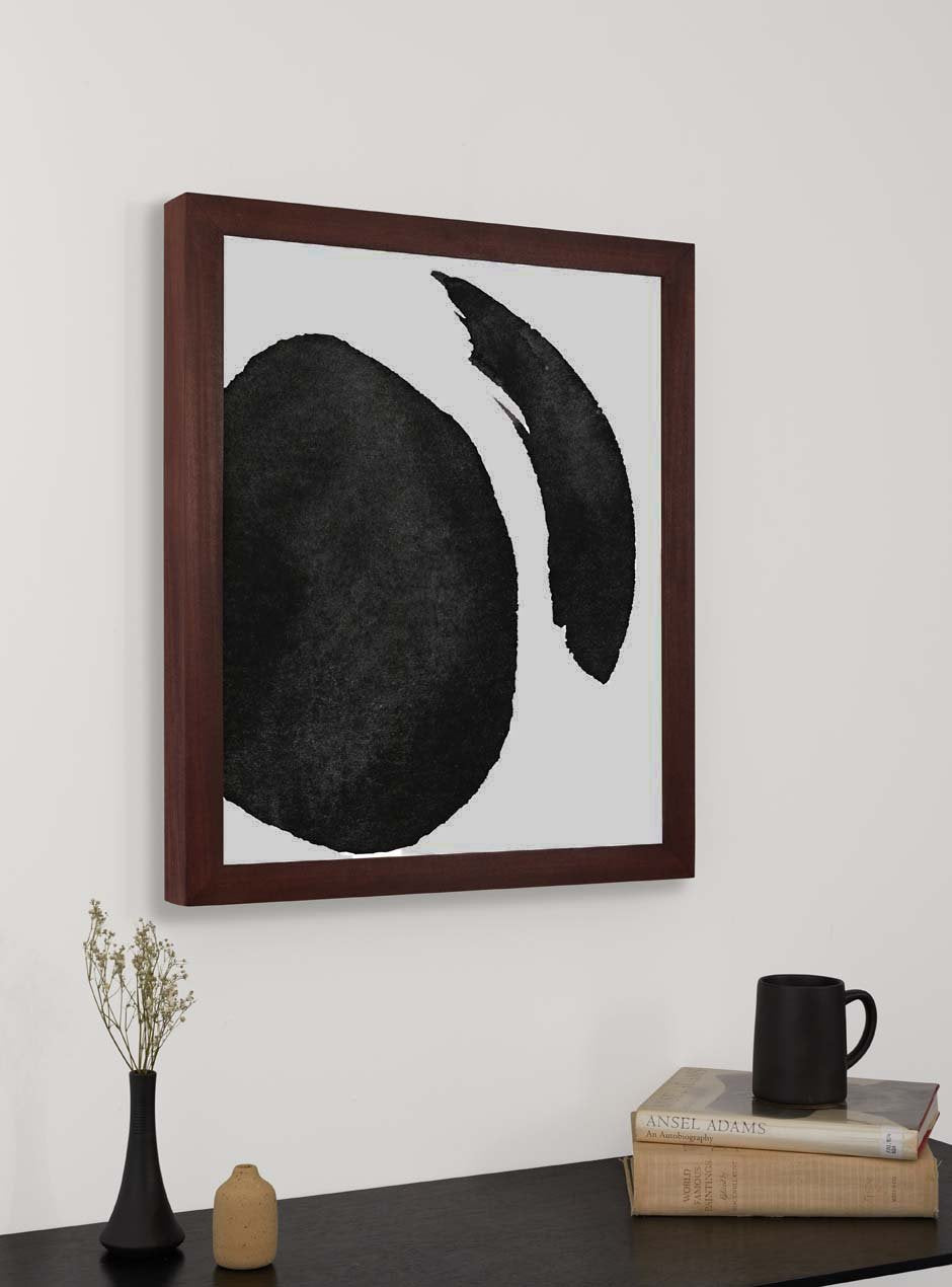 dark stained wooden frame holding abstract painting hung above table with various objects 