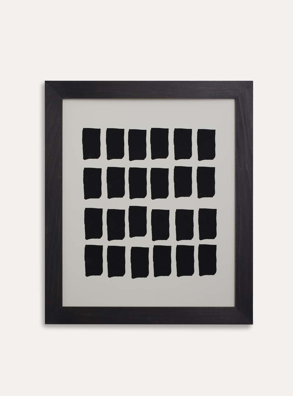 black squares  and white background abstract print in black frame on white wall
