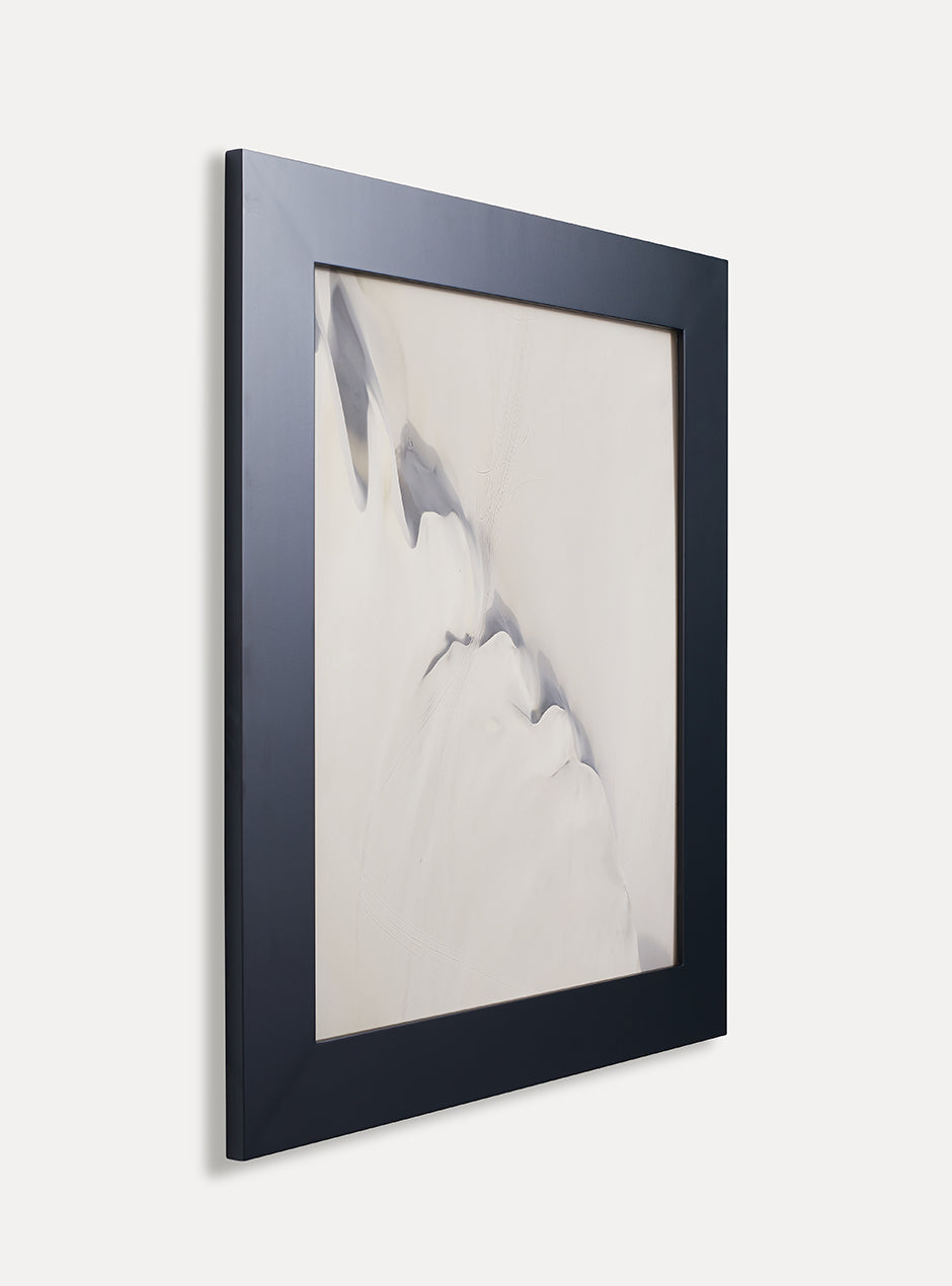 Side view of black frame holding abstract art