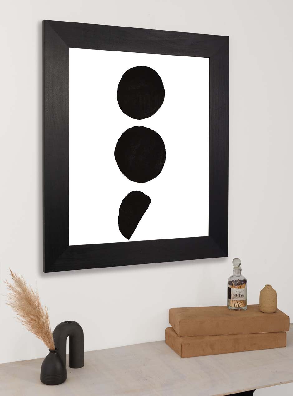 3 black dots on white background print framed in black frame