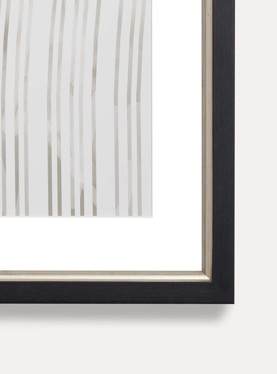 close up of corner of black frame with silver inner detailing 