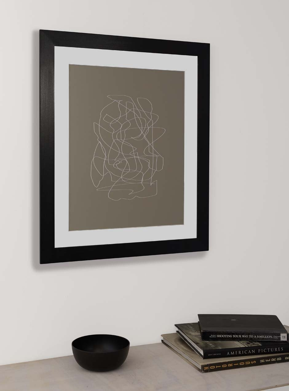 black solid poplar frame with neutral blotchy modern artwork against white wall