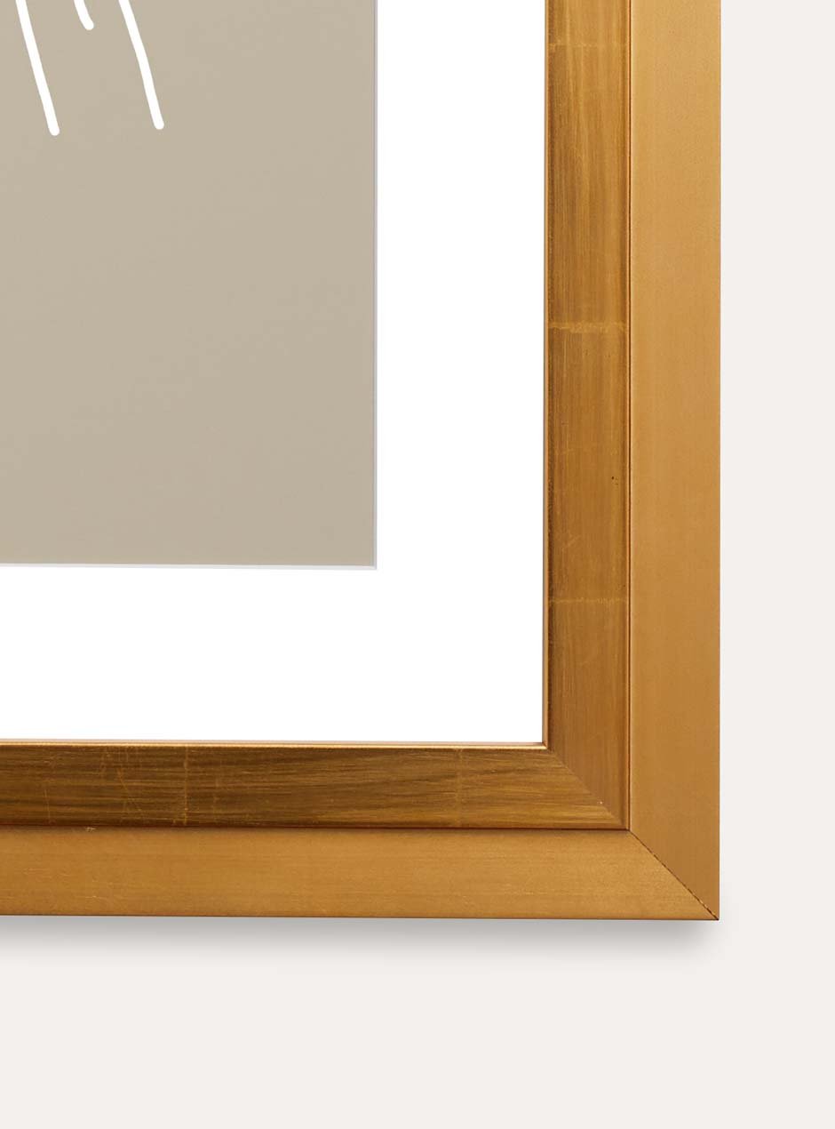 close up of corner of gold frame holding abstract art