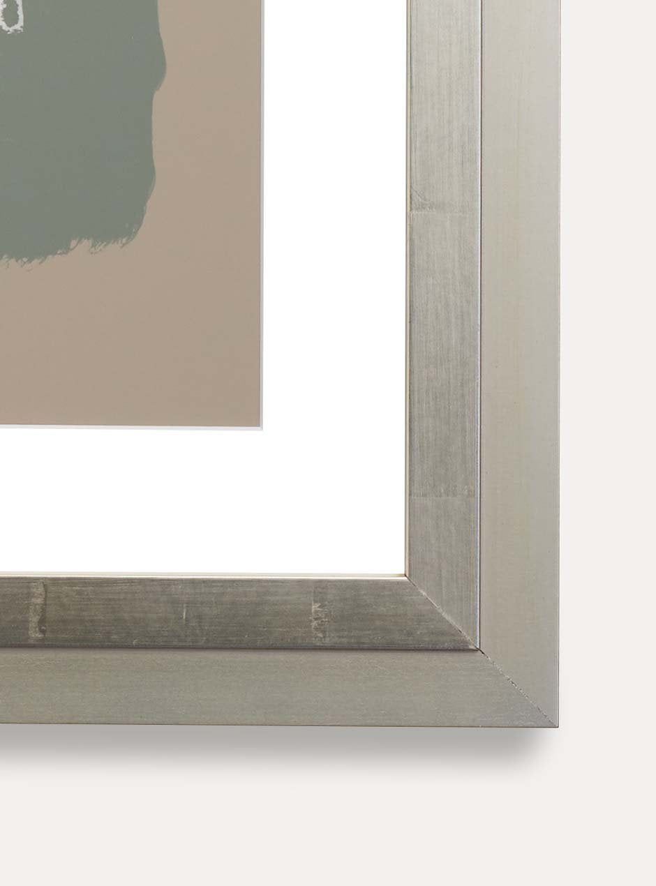 close up of corner of silver frame holding abstract art