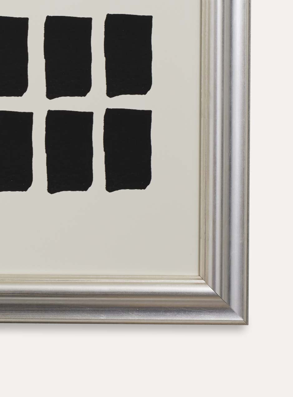 detail shot showing the bottom right corner of high quality metallic silver moulding shiny picture frame detailed with several grooves showing modern black paint pieces 