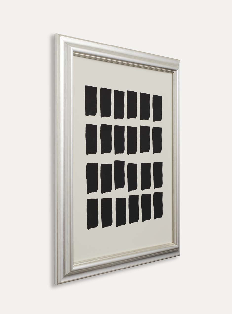 side profile showing depth of high quality metallic silver moulding shiny picture frame detailed with several grooves showing modern black paint pieces 