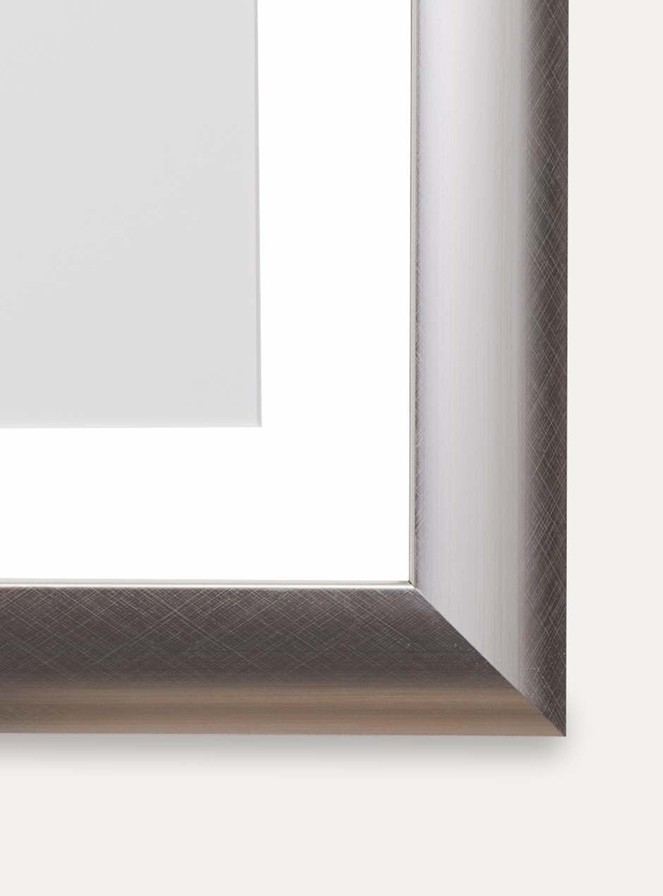 close up of corner silver frame holding abstract art