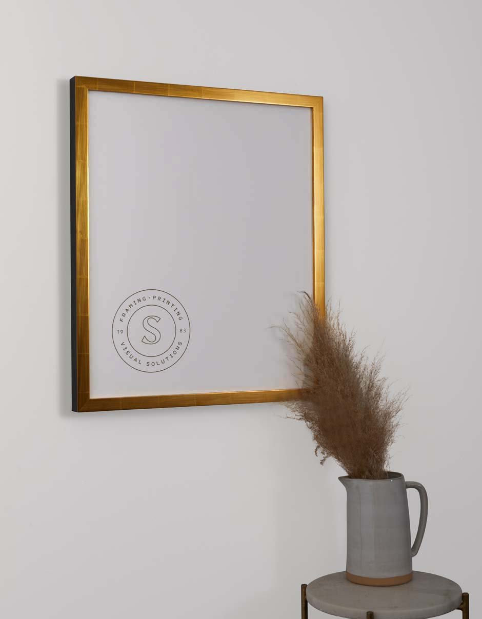 gold frame hung above table