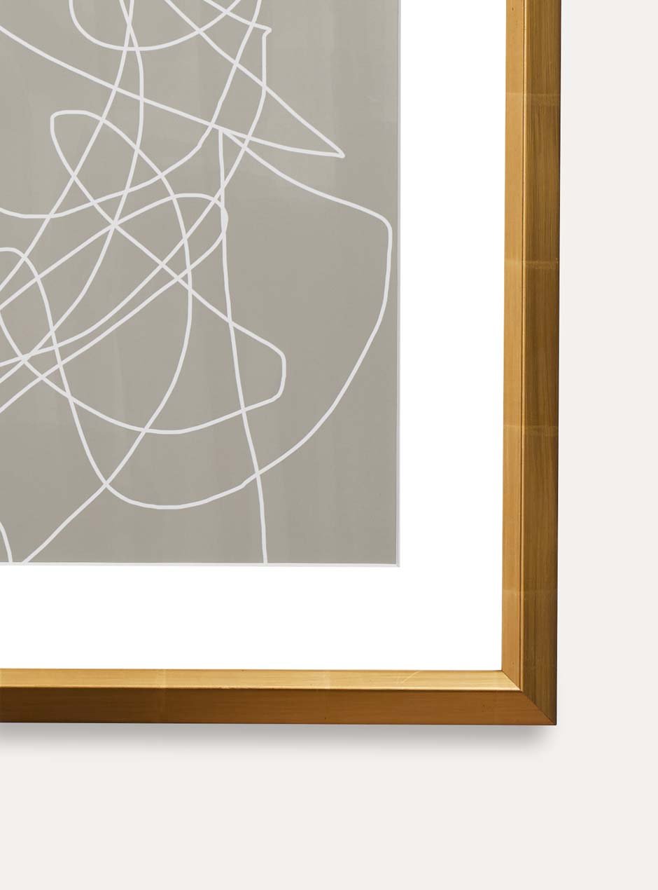 close up of corner of gold frame with abstract art
