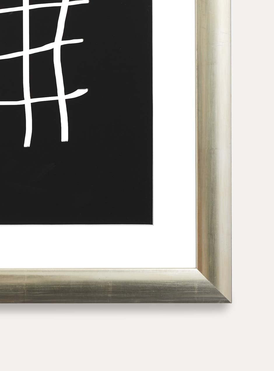 close up of corner of silver frame holding abstract art