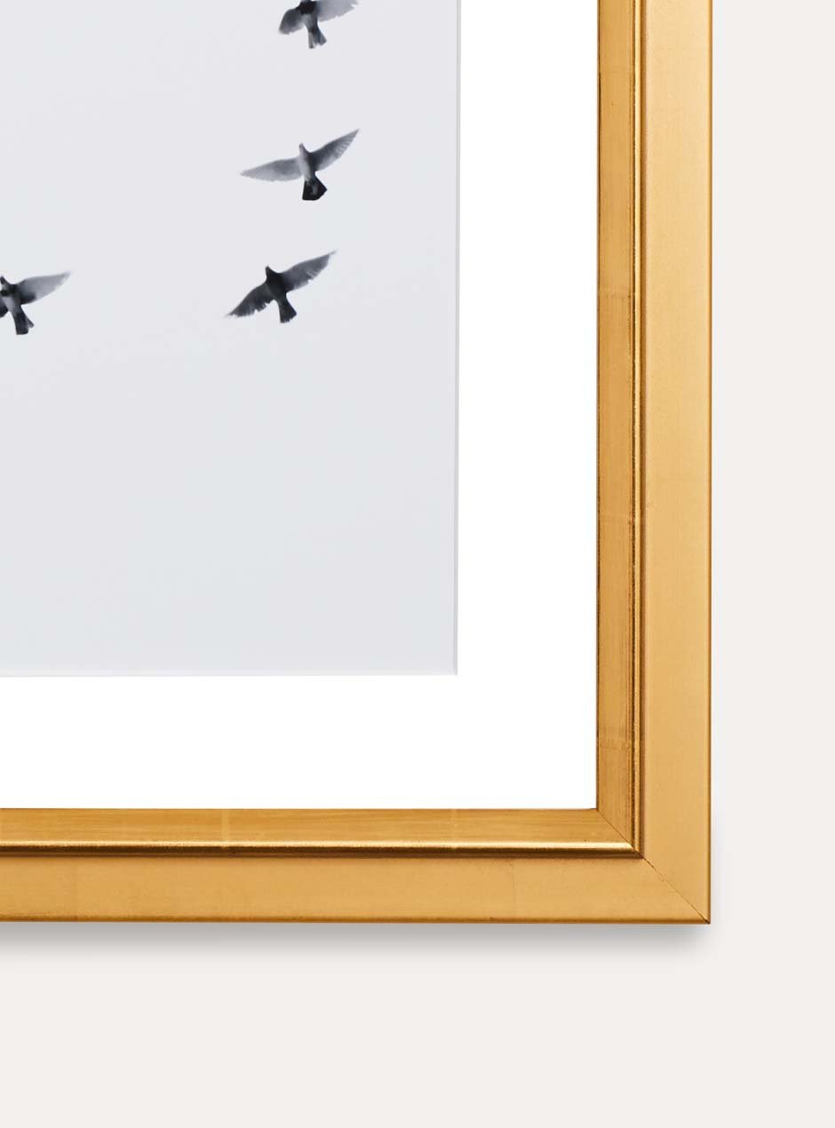 close up of corner of gold frame holding abstract art
