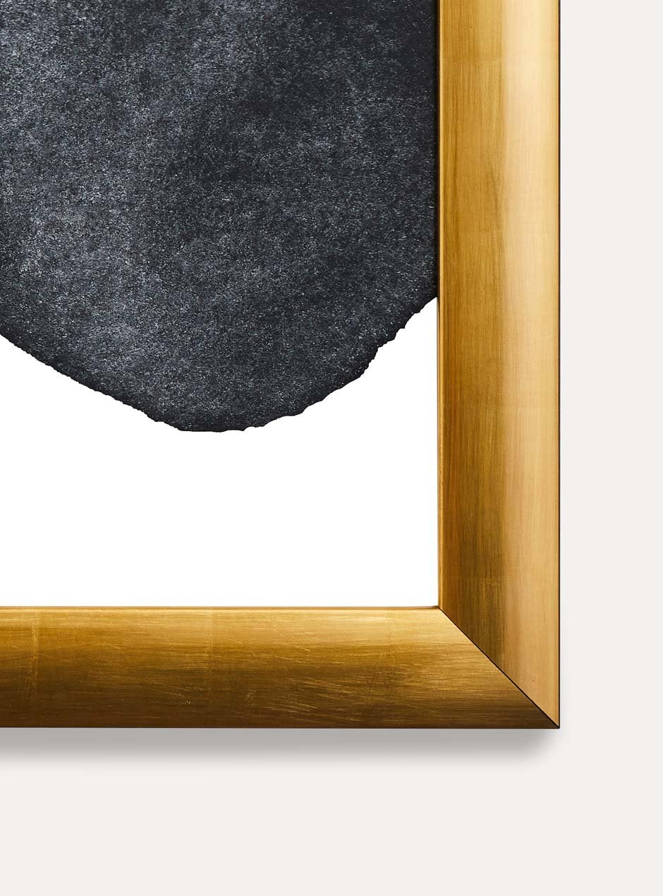 close up of corner of gold frame holding abstract art