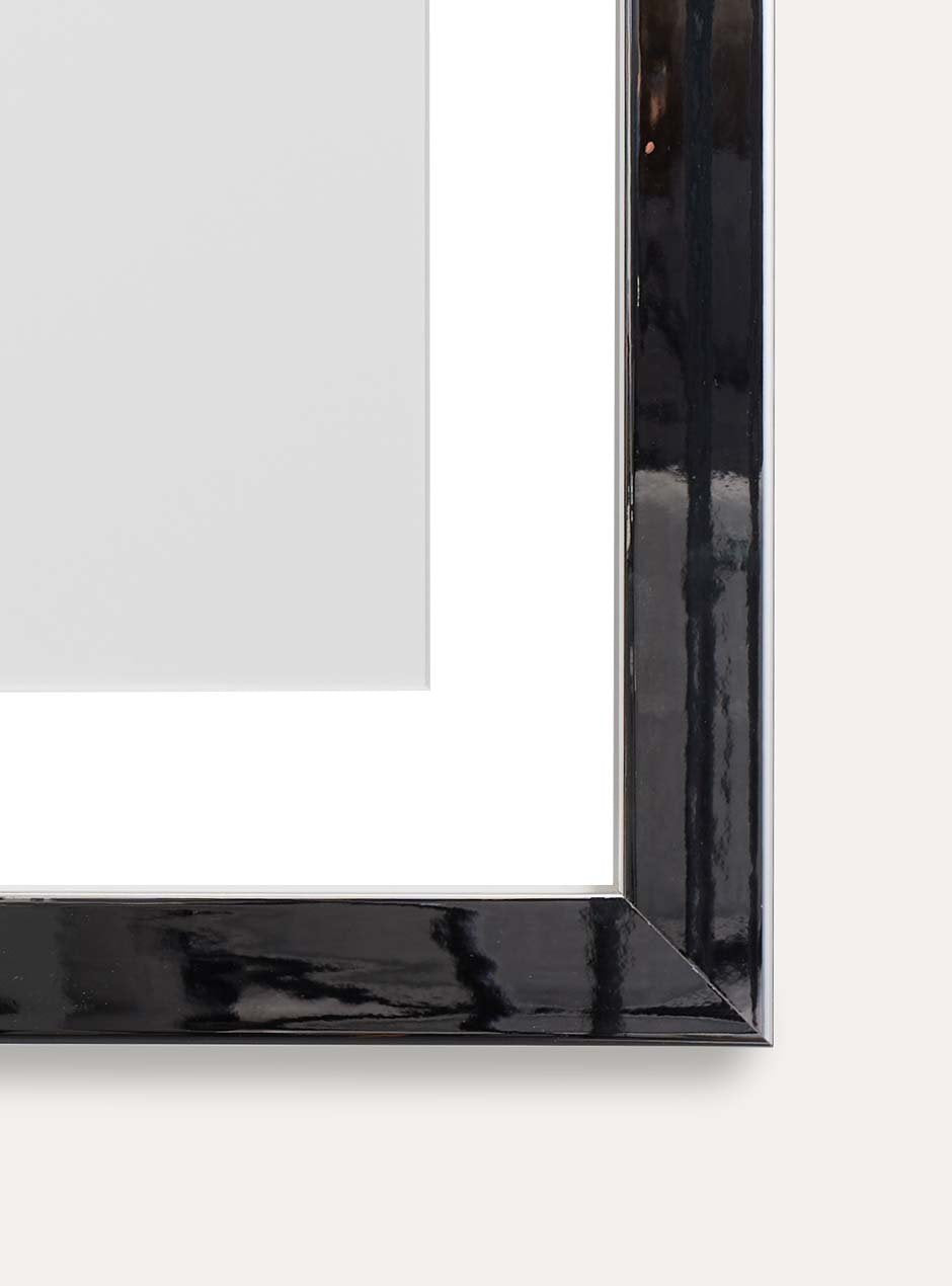 close up of bottom corner of mirrored frame with skyframe logo inside