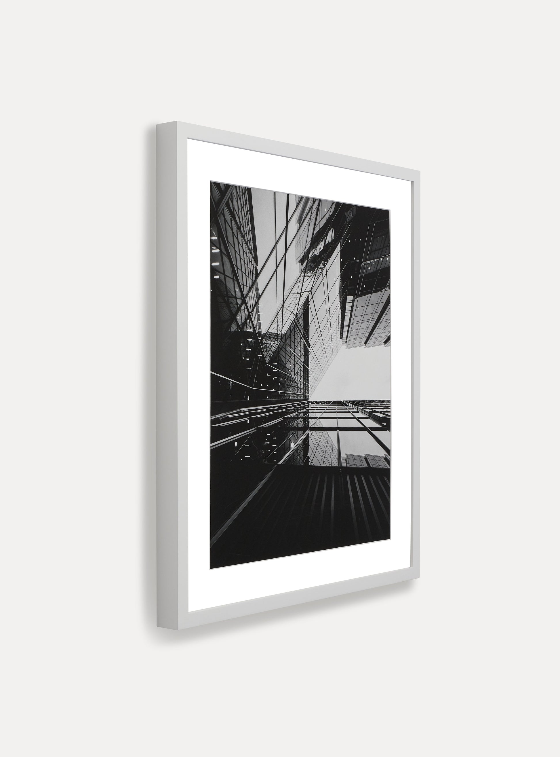 Side photo of a wooden picture frame on an off-white wall