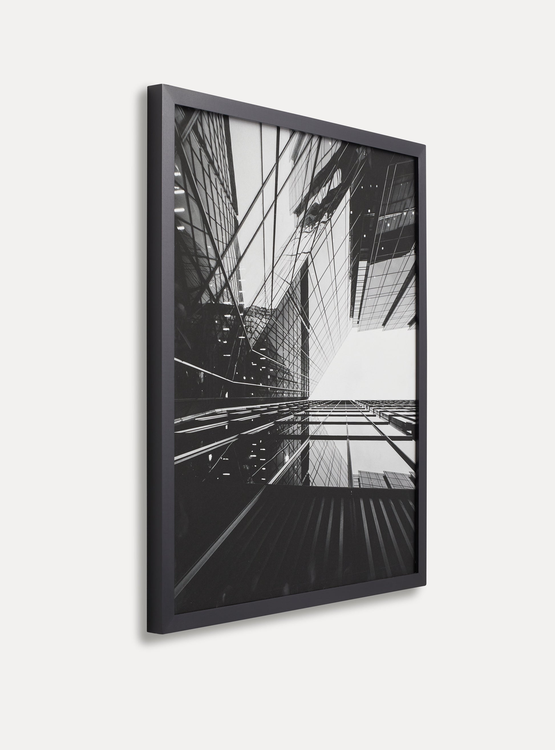 Side photo of a wooden picture frame on an off-white wall