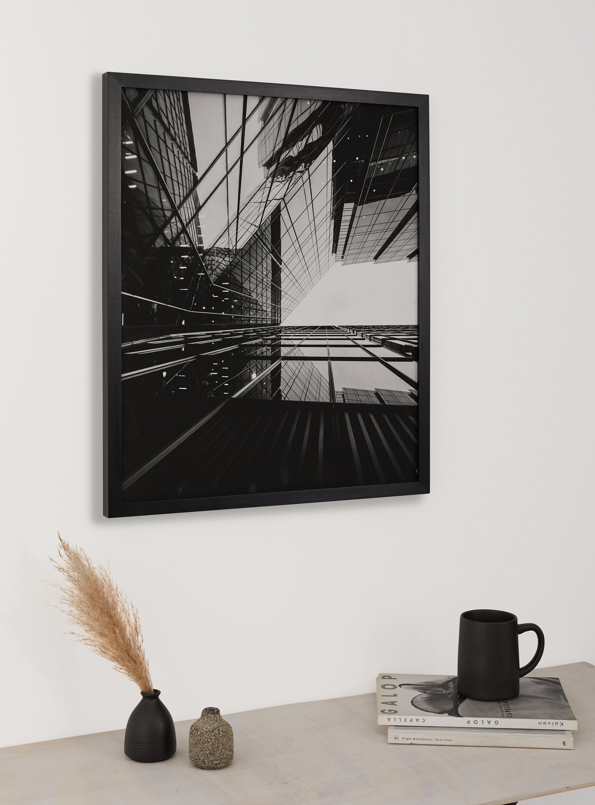 Photograph of a frame in a home with a table underneath showing various items