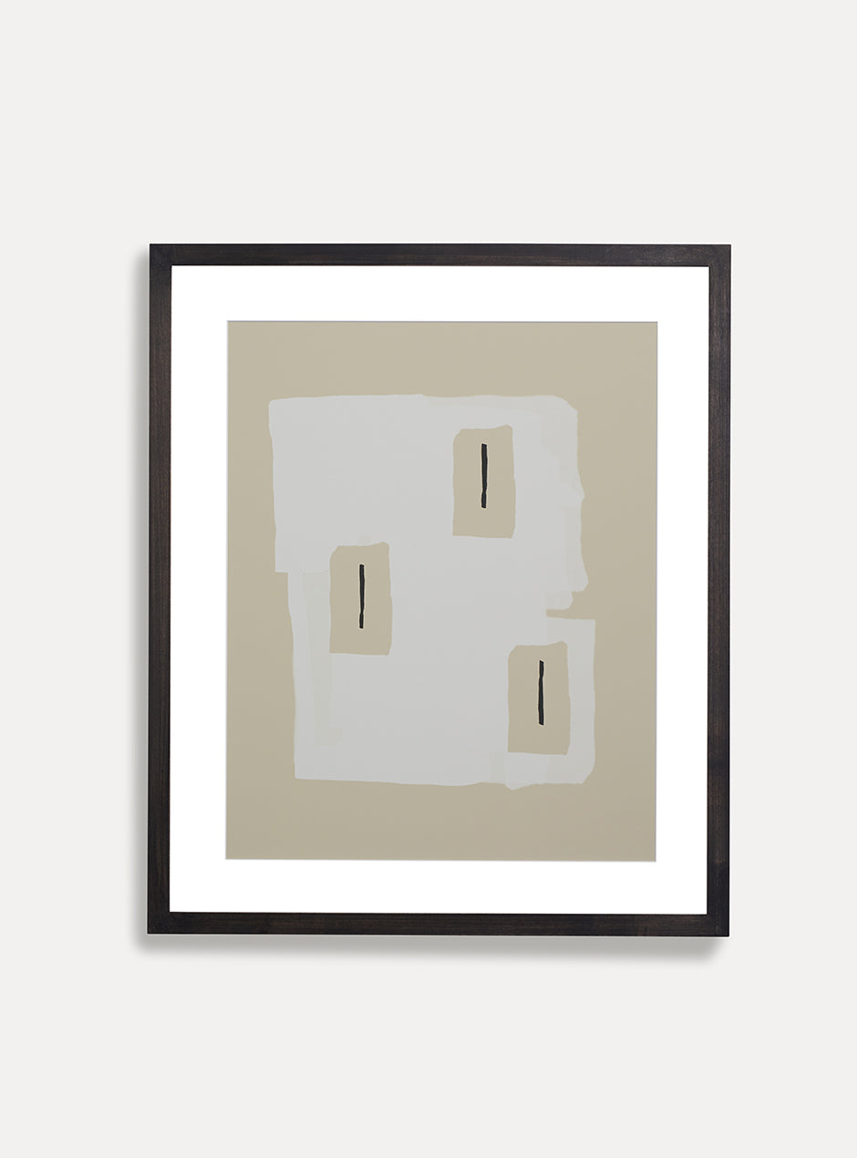 tan and white abstract print in black frame on white wall